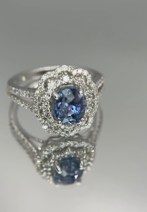 Finished blue sapphire double-halo ring created for a returning Sookjai client