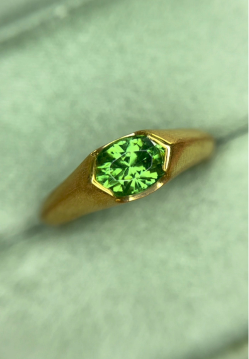 Green zircon modern signet ring with a brushed yellow-gold finish